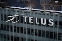 The Telus Corporation logo is seen on the outside of the company's headquarters in downtown Vancouver, B.C., Thursday, Jan. 19, 2023. Telus has signed a partnership with an Australian electric vehicle charging company, planning to install up to 5,000 chargers across Canada. THE CANADIAN PRESS/Darryl Dyck