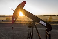 A pumpjack draws out oil and gas from a well head as the sun sets near Calgary, Alta., Sunday, Oct. 9, 2022. Crescent Point Energy Corp. says it has signed an agreement with Paramount Resources Ltd. to acquire additional Kaybob Duvernay assets for $375 million. THE CANADIAN PRESS/Jeff McIntosh