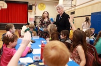 British Columbia Finance Minister Katrine Conroy and school principal Vicki Ives serve up a hot lunch for students at Ruth King Elementary during a photo-op ahead of the budget while in Langford, B.C., Monday, Feb. 27, 2023. THE CANADIAN PRESS/Chad Hipolito