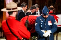 Mark Mulroney, left to right, and brothers Nicolas Mulroney and Ben Mulroney visit the casket of their father and former prime minister Brian Mulroney as he lies in repose at St. Patrick's Basilica in Montreal on Friday, March 22, 2024. THE CANADIAN PRESS/Sean Kilpatrick