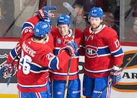 Montreal Canadiens' Jordan Harris (54) celebrates his goal against the Arizona Coyotes with teammates Johnathan Kovacevic (26), Jake Evans (hidden) and Josh Anderson (17) during second period NHL hockey action in Montreal on Tuesday, Feb. 27, 2024. THE CANADIAN PRESS/Christinne Muschi