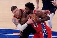New York Knicks' Isaiah Hartenstein defends Philadelphia 76ers' Joel Embiid, right, during the second half of Game 2 in an NBA basketball first-round playoff series Monday, April 22, 2024, in New York. (AP Photo/Frank Franklin II)