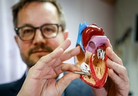 Dr. Derek Exner, a cardiologist and heart rhythm specialist with Alberta Health Services, holds an example of the miniaturized pacemaker against a model where it would be installed in a human heart at the University of Calgary medical centre in Calgary. Thursday, Feb. 9, 2023. THE CANADIAN PRESS/Jeff McIntosh