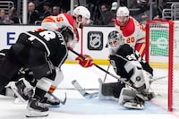 Los Angeles Kings goaltender Pheonix Copley (29) stops a shot from Calgary Flames defenseman Noah Hanifin (55) during the third period of an NHL hockey game Monday, March 20, 2023, in Los Angeles. (AP Photo/Marcio Jose Sanchez)