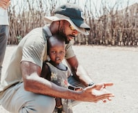 Edmonton Elks CFL receiver Eugene Lewis is shown holding a child in this handout image provided by World Vision Canada. Like many, Lewis had seen the commercials that ask for donations to help less fortunate children in Africa but nothing prepared him to see their plight up close and personal. This offseason, the Edmonton Elks receiver served as an ambassador with World Vision Canada and spent time on a mission to Africa. 
THE CANADIAN PRESS/HO-World Vision Canada
**MANDATORY CREDIT**