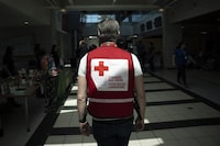 A representative from the Canadian Red Cross works at an evacuation centre in Halifax on Tuesday, May 30, 2023.&nbsp;Community groups in New Brunswick are coming together to help more than 100 people in Fredericton who fled a burning apartment building last Thursday. THE CANADIAN PRESS/Darren Calabrese