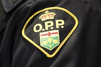 An Ontario Provincial Police logo is shown during a press conference announcing the seizure of 55 kilograms of cocaine and about $800,000 in Canadian currency during a press conference after making a huge coordinated seizure involving many different agencies including the United States, in Barrie, Ont., on Wednesday, April 3, 2019. The source of the drugs came from Mexico, traveling through the United States and ending in Ontario. THE CANADIAN PRESS/Nathan Denette