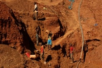 FILE PHOTO: Illegal artisanal gold miners work at an open mine after occupying parts of Smithfield farm, owned by the former President Robert Mugabe's wife Grace Mugabe, in Mazowe, Zimbabwe, April 5, 2018. Picture taken April 5, 2018. REUTERS/Philimon Bulawayo - RC144DE808F0/File Photo