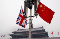 FILE - British and Chinese national flags are seen on display in front of the Tiananmen Gate in Beijing, China, Jan. 17, 2008. Beijing confirmed Friday, Jan. 26, 2024, that longtime British businessperson Ian J. Stones in China had been sentenced to five years in prison in 2022 on an espionage charge. (AP Photo/Andy Wong, File)