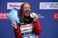 Silver medallist Canada's Molly Carlson celebrates on the podium during the medal ceremony of the final of the women's high diving round 3 & 4 during the 2024 World Aquatics Championships at Doha Port in Doha on February 14, 2024. (Photo by Oli SCARFF / AFP) (Photo by OLI SCARFF/AFP via Getty Images)