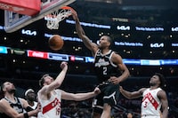 Los Angeles Clippers' Kawhi Leonard (2) dunks over Toronto Raptors' Jakob Poeltl (19) during second half of an NBA basketball game Wednesday, March 8, 2023, in Los Angeles. (AP Photo/Jae C. Hong)