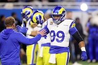 DETROIT, MICHIGAN - JANUARY 14: Aaron Donald #99 of the Los Angeles Rams shakes hands with Head coach Sean McVay prior to a game against the Detroit Lions in the NFC Wild Card Playoffs at Ford Field on January 14, 2024 in Detroit, Michigan. (Photo by Gregory Shamus/Getty Images)