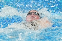 Ingrid Wilm of Canada competes in the women's 100m Backstroke Semifinal at the World Aquatics Championships in Doha, Qatar, Monday, Feb. 12, 2024. (AP Photo/Hassan Ammar)