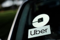 FILE PHOTO: An Uber logo is shown on a rideshare vehicle during a statewide day of action to demand that ride-hailing companies Uber and Lyft follow California law and grant drivers "basic employee rights'', in Los Angeles, California, U.S., August 20, 2020. REUTERS/Mike Blake/File Photo