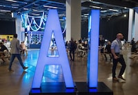 <p>People walk past an AI sign at the All In artificial intelligence conference Thursday, September 28, 2023 &nbsp;in Montreal. Canada's federal government has used artificial intelligence in nearly 300 projects and initiatives, new research has found — including to help predict the outcome of tax cases, sort temporary visa applications and promote diversity in hiring. THE CANADIAN PRESS/Ryan Remiorz</p>