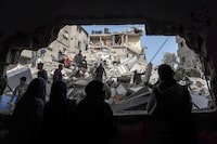 Palestinians check the rubble of buildings that were destroyed following overnight Israeli bombardment in Rafah, in the southern Gaza Strip, on March 27, 2024, amid the ongoing conflict between Israel and the Palestinian militant group Hamas. (Photo by MOHAMMED ABED / AFP) (Photo by MOHAMMED ABED/AFP via Getty Images)