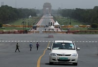 FILE PHOTO: An electric vehicle (EV) is driven on the road near India Gate in New Delhi, India, August 28, 2023. REUTERS/Anushree Fadnavis/File Photo