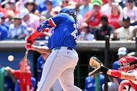 Mar 24, 2024; Clearwater, Florida, USA; Toronto Blue Jays first baseman Vladimir Guerrero Jr. (27) hits a single in the first inning of the spring training game against the Philadelphia Phillies at BayCare Ballpark. Mandatory Credit: Jonathan Dyer-USA TODAY Sports