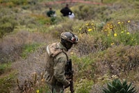 A navy officer walks near the scene where human remains were found near La Bocana Beach, Santo Tomas delegation, in Ensenada, Baja California State, Mexico, on May 3, 2024.   . The FBI said on Friday that three bodies were found in Mexico's Baja California, near an area where two Australians and an American went missing last week during a surfing trip. "We confirm there were three individuals found deceased in Santo Tomas, Baja California," a statement from the FBI's office in San Diego said without providing identities of the victims. (Photo by Guillermo Arias / AFP) (Photo by GUILLERMO ARIAS/AFP via Getty Images)