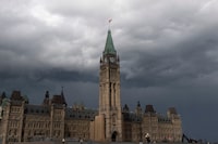 Storm clouds pass by the Peace tower and Parliament hill Tuesday August 18, 2020 in Ottawa. The parliamentary budget office says a one-time payment this fall to people with disabilities will cost the federal treasury $792 million. THE CANADIAN PRESS/Adrian Wyld