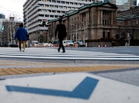 FILE PHOTO: People walk in front of the Bank of Japan building in Tokyo, Japan January 23, 2024. REUTERS/Kim Kyung-Hoon/File Photo