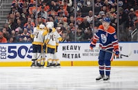 Nashville Predators celebrate a goal as Edmonton Oilers' Connor McDavid (97) skates to the bench during second period NHL action in Edmonton on Saturday November 4, 2023. THE CANADIAN PRESS/Jason Franson
