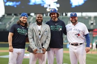 SEATTLE, WASHINGTON - JULY 10: Vladimir Guerrero Jr. #27 of the Toronto Blue Jays poses for photos with teammates Bo Bichette, Jordan Romano, and Manager John Schneider after winning the T-Mobile Home Run Derby at T-Mobile Park on July 10, 2023 in Seattle, Washington. (Photo by Tim Nwachukwu/Getty Images)