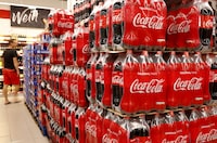 FILE PHOTO: Bottles of Coca-Cola are displayed at a supermarket in Glattbrugg, Switzerland June 26, 2020. REUTERS/Arnd Wiegmann/File Photo