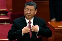 Chinese President Xi Jinping adjusts his jacket during the closing session of the National People's Congress held at the Great Hall of the People in Beijing, Monday, March 11, 2024. This year, China's national legislature resumed its annual in-person meetings in a way that it hadn't done since before the pandemic. Though officials say China is back to business, in practice, the meetings have become even more tightly scripted to broadcast Chinese leader Xi Jinping's message, leaving little room for the spontaneity and open engagement the sessions once offered before COVID-19. (AP Photo/Ng Han Guan)