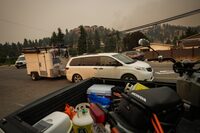 Evacuees leave with a trailer of belongings after a wildfire evacuation alert was upgraded to an order and they were forced to leave the Wilden neighbourhood near Knox Mountain, in Kelowna, B.C., Friday, Aug. 18, 2023. Evacuated residents in Kelowna are able to return home after all previous evacuation orders within city limits were lifted late yesterday. THE CANADIAN PRESS/Darryl Dyck