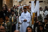 Scouts carry a statue of Jesus Christ during the Good Friday procession in Jerusalem's Old City, on March 29, 2024. (Photo by RONALDO SCHEMIDT / AFP) (Photo by RONALDO SCHEMIDT/AFP via Getty Images)