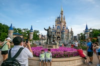 FILE - People visit Magic Kingdom Park at Walt Disney World Resort in Lake Buena Vista, Florida, on April 18, 2022.