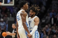North Carolina guard RJ Davis (4) and North Carolina forward Harrison Ingram (55) celebrate a three-point shot against Michigan State during the first half of a second-round college basketball game in the NCAA Tournament, Saturday, March 23, 2024, in Charlotte, N.C. (AP Photo/Mike Stewart)