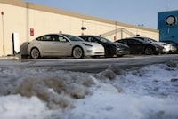 CHICAGO, ILLINOIS - JANUARY 17: Tesla vehicles charge in a parking lot on January 17, 2024 in Chicago, Illinois. Recent research findings show that below-freezing temperatures reduced driving range up to 70% on 18 popular EV models, including those from Tesla. (Photo by Kevin Dietsch/Getty Images)