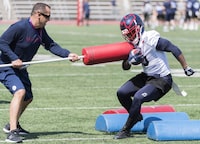 Montreal Alouettes running back Stefan Logan, right, runs a drill with running backs coach Andre Bolduc during training camp in Montreal, Monday, May 20, 2019. Dave Dickenson will have two newcomers to his Calgary Stampeders coaching staff this season. Dickenson, Calgary's head coach and general manager, unveiled his 2024 staff Monday and it includes Bolduc (running backs) and Ryan Williams (quarterbacks). THE CANADIAN PRESS/Graham Hughes