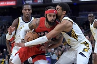 Toronto Raptors guard Gary Trent Jr. collides with Indiana Pacers guard Tyrese Haliburton while driving toward the basket during the second half of an NBA basketball game Wednesday, Nov. 22, 2023, in Indianapolis. (AP Photo/Marc Lebryk)