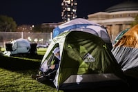 A protester rests in their tent in a pro-Palestinian encampment set up on the University of Toronto campus in Toronto on Thursday, May 2, 2024. THE CANADIAN PRESS/Christopher Katsarov