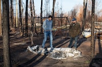 Prime Minister Justin Trudeau, left, tours Chaal Cadieux's devastated property from the wildfire in Enterprise, Northwest Territories on Wednesday, October 11, 2023. THE CANADIAN PRESS/Jason Franson