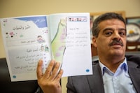 Ihab Shukri, who leads development of scientific curriculum at the Palestinian Ministry of Education, shows a locally-developed textbook
April 17, 2024
(Nathan VanderKlippe/The Globe and Mail)