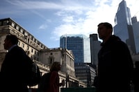 People walk outside the Bank of England in London on May 11.