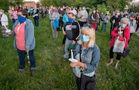 Participants react during a vigil for COVID-19 victims at the Orchard Villa long-term care home in Pickering, Ont. on Monday, June 15, 2020. THE CANADIAN PRESS/Frank Gunn