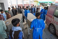 Paramedics carry slain migrant labourers' coffins at a hospital in Quetta on April 13, 2024, after they were killed by gunmen near the city of Naushki in Balochistan province. Gunmen killed 11 people in southwest Pakistan, officials said on April 13, with police searching for suspected separatist militants after migrant labourers were singled out for execution. (Photo by Banaras KHAN / AFP) (Photo by BANARAS KHAN/AFP via Getty Images)