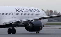 Air Canada says it is conducting a review after a passenger boarding a flight from Toronto to Dubai opened a cabin door and fell to the tarmac at Pearson Airport. An Air Canada jet taxis at the airport, Wednesday, Nov. 15, 2023 in Vancouver. THE CANADIAN PRESS/Adrian Wyld