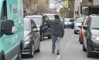 <p>A homeless native man panhandles between cars stopped at a red light in Montreal on Wednesday, May 4, 2022. An Ontario court has struck down sections of the province's panhandling law as unconstitutional. THE CANADIAN PRESS/Paul Chiasson</p>