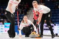 Canada's skip Rachel Homan, centre, watches her shot as Sarah Wilkes, left, and Emma Miskew prepare to sweep the stone during World Women’s Curling Championship action against Japan in Sydney, N.S. on Wednesday, March 20, 2024. THE CANADIAN PRESS/Darren Calabrese