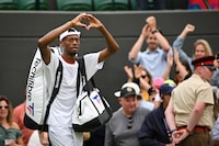 US player Christopher Eubanks does a heart with his hands as he acknowledges the audience while leaving the court following his defeat against Russia's Daniil Medvedev during their men's singles quarter-finals tennis match on the tenth day of the 2023 Wimbledon Championships at The All England Lawn Tennis Club in Wimbledon, southwest London, on July 12, 2023. (Photo by Glyn KIRK / AFP) / RESTRICTED TO EDITORIAL USE (Photo by GLYN KIRK/AFP via Getty Images)