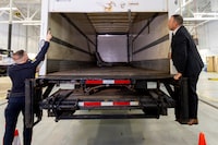 Police officers open the back of the truck used in the heist after authorities gave details of the arrests made one year after some 400 kg (882 pounds) of gold and almost $2 million USD in cash was stolen from Toronto Pearson International Airport, at a news conference in Brampton, Ontario, Canada April 17, 2024.  REUTERS/Carlos Osorio