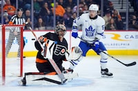 Philadelphia Flyers' Samuel Ersson, left, cannot block a goal by Toronto Maple Leafs' William Nylander as Tyler Bertuzzi, right, looks on during the third period of an NHL hockey game, Tuesday, March 19, 2024, in Philadelphia. (AP Photo/Matt Slocum)