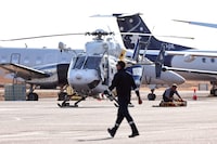 A Care Flight helicopter is seen on the tarmac of the Darwin International Airport in Darwin on August 27, 2023, as rescue work is in progress to transport those injured in the US Osprey military aircraft crash at a remote island north of Australia's mainland. Three US Marines died on August 27 after an Osprey aircraft crashed on a remote tropical island north of Australia during war games, US military officials said. (Photo by DAVID GRAY / AFP) (Photo by DAVID GRAY/AFP via Getty Images)