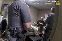 In this image taken from New York State Police body camera video that was obtained by WMTW-TV 8 in Portland, Maine, New York State police interview Army Reservist Robert Card, the man responsible for Maine's deadliest mass shooting, at Camp Smith in Cortlandt, New York on July 16, 2023. Card told state police before being hospitalized that fellow soldiers were worried about him because he was ”gonna friggin' do something,” according to police body cam video released under New York's Freedom of Information Law. Card went on to kill 18 people and wounded 13 at a bowling alley and a bar in Lewiston, Maine, leading to the largest manhunt in state history and tens of thousands of people sheltering in their homes. Card's body was found two days later. He had died by suicide. (WMTW-TV 8/New York State police via AP)